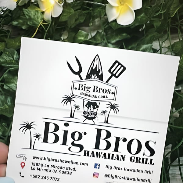 Big Bros Hawaiian Grill business card with logo, address, phone, and social media on a leafy background.